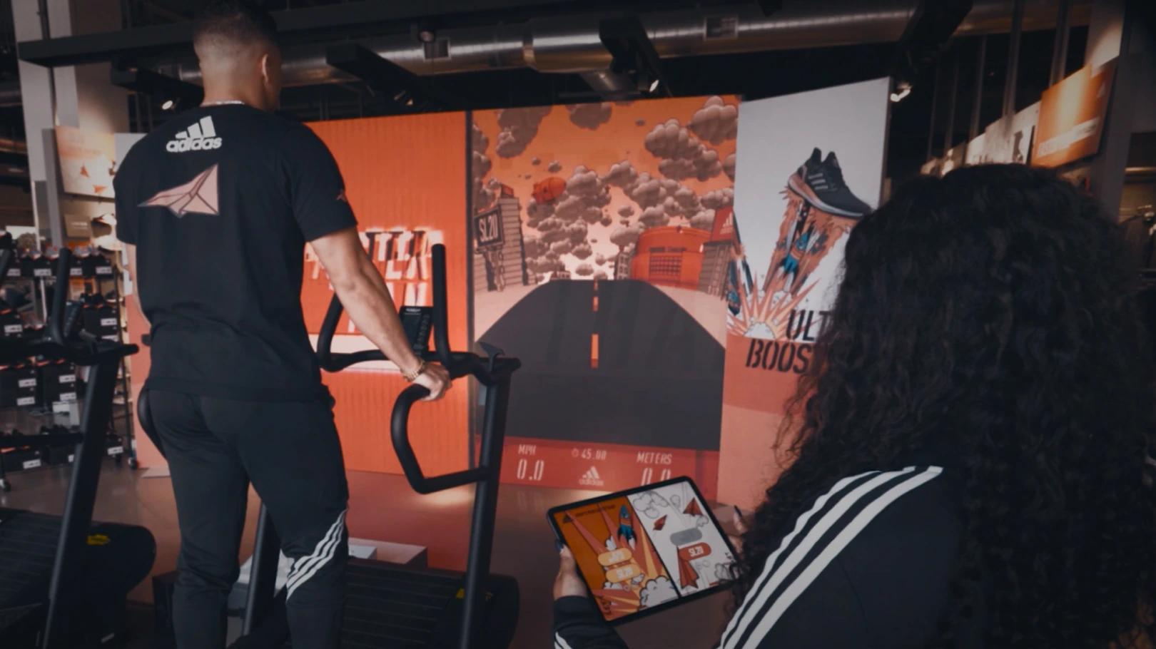 A man running on a treadmill with a woman standing beside him tracking his data on a tablet